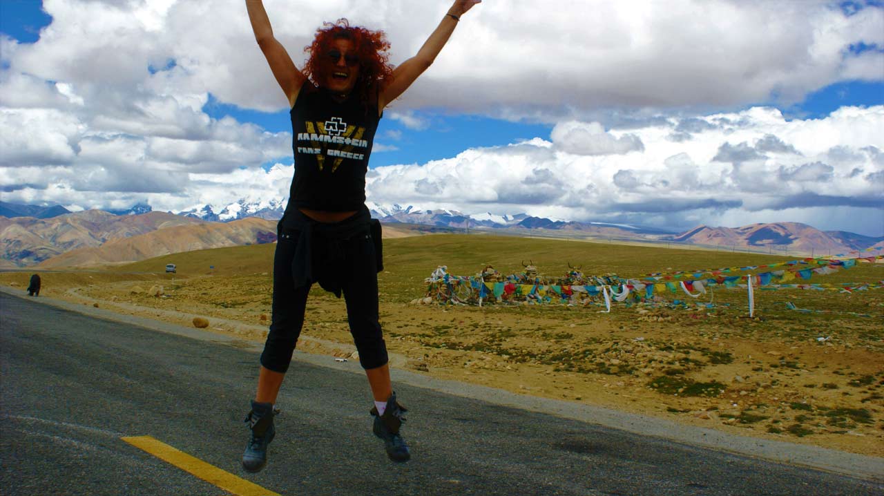 curly nomad asia nepal tibet himalaya crossing kathmandu lhasa woman jumping photo