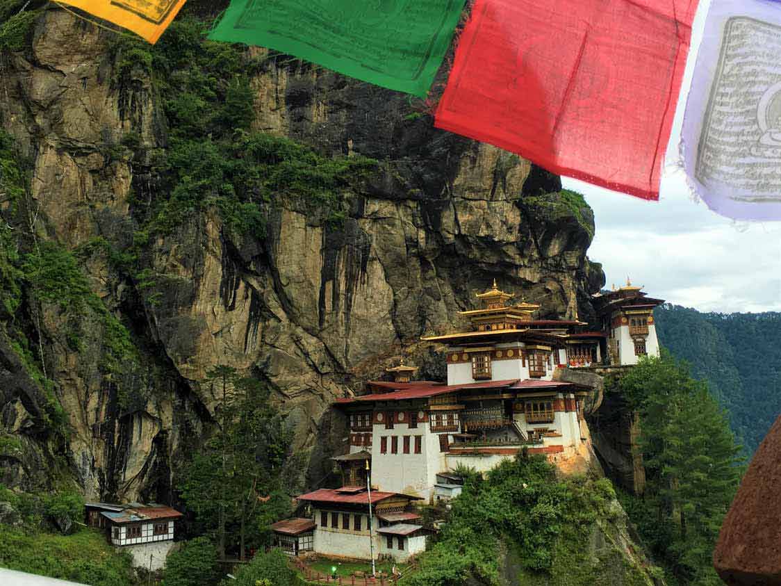 curly nomad asia bhutan paro taktsang tigers nest hike monastery prayer flags photo